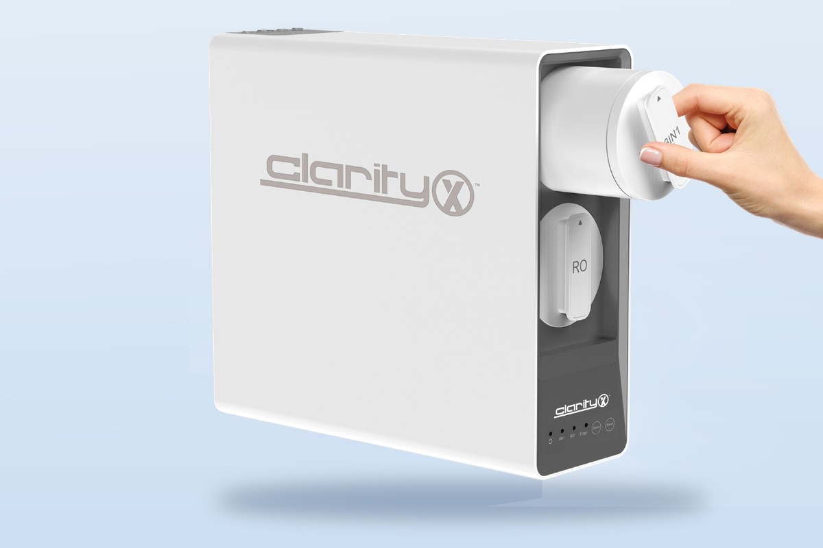 Nuvia ClarityX tankless reverse-osmosis system, with a hand changing a quick-change filter