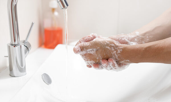 Washing,Hands,With,Soap.,Man,Cleaning,Hands,In,A,Bathroom Washing hands with soap. Man cleaning hands in a bathroom