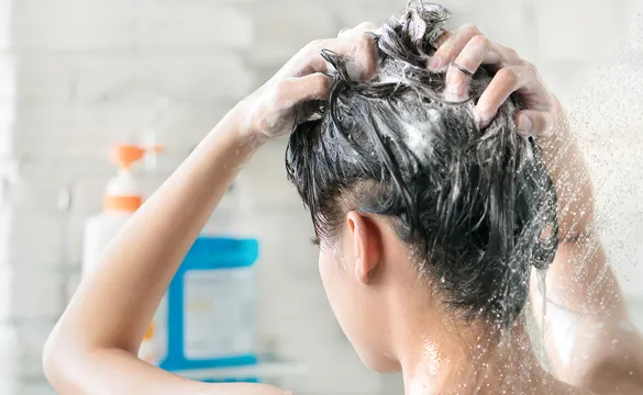 A woman washing her hair in the shower