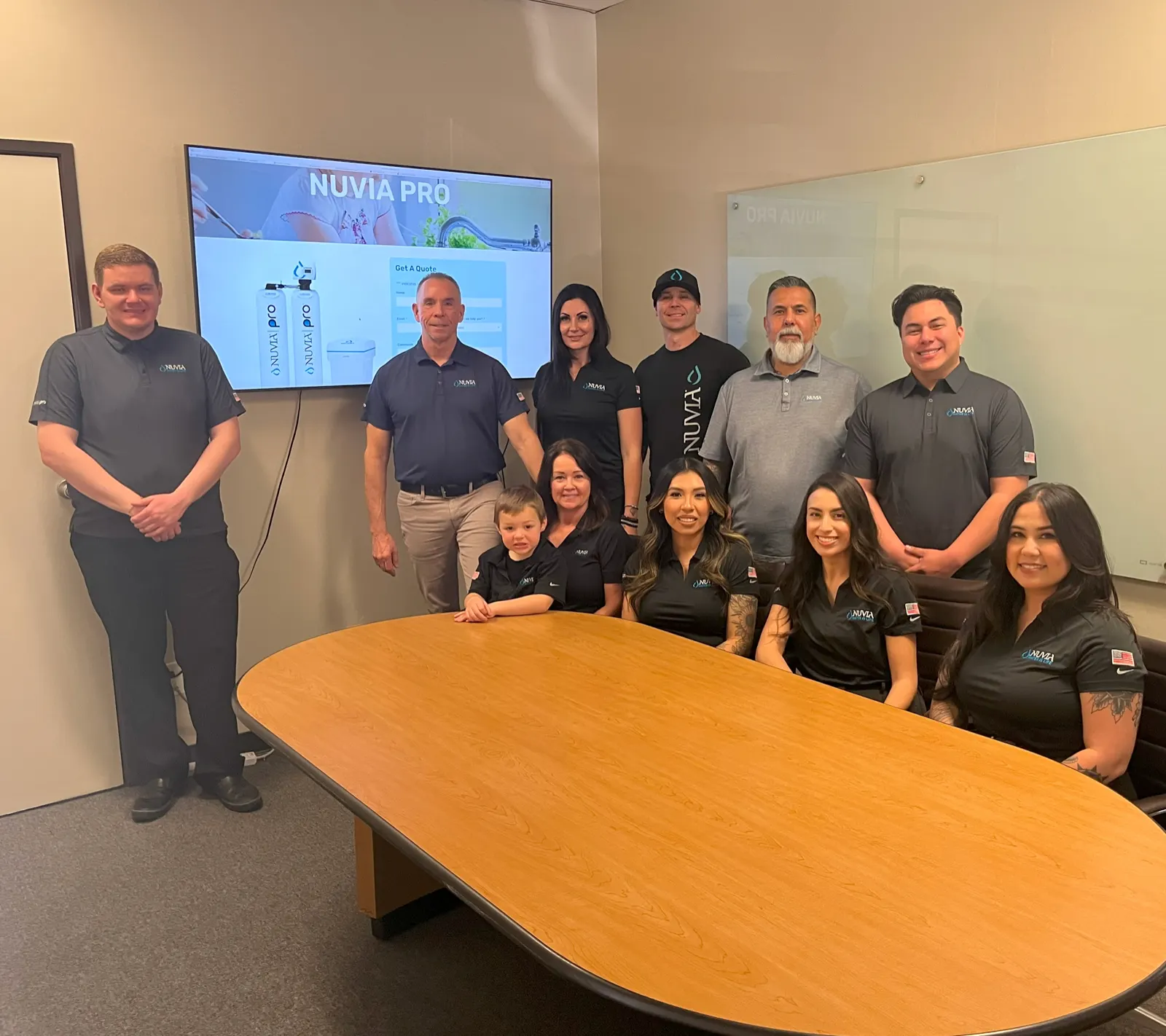 Nuvia Water office team gathered in conference room – diverse staff collaborating on water and air purification solutions