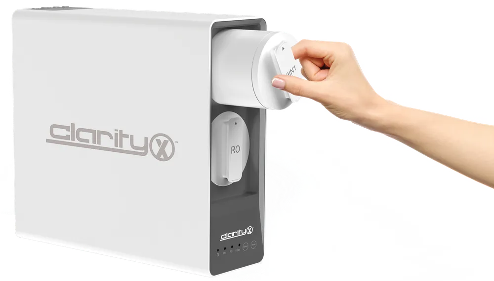 Nuvia ClarityX unit with a hand turning the filter