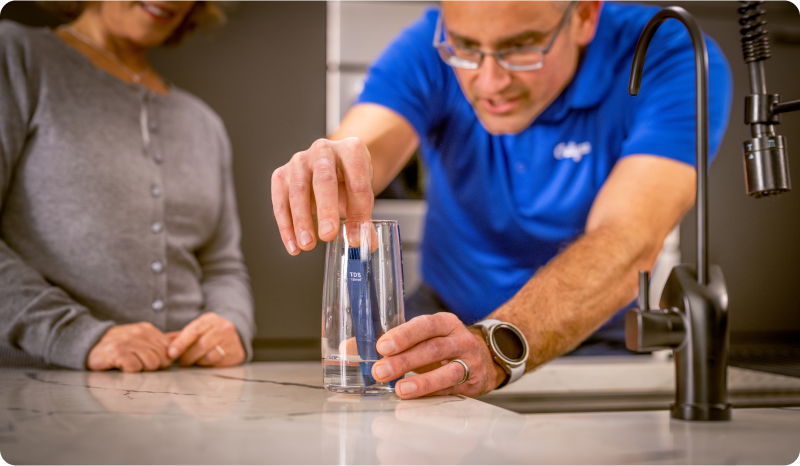 Professional technician performing a free water quality test in Corona, CA.