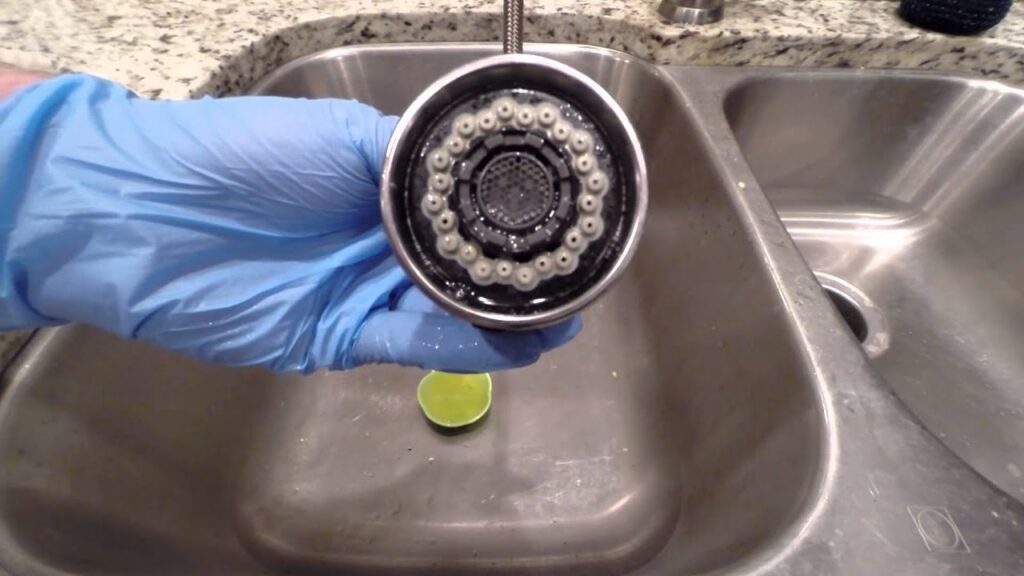 White mineral buildup on a kitchen faucet caused by hard water. 10 Problems Caused by Hard Water
